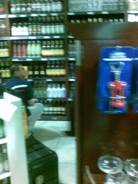 our favorite presidential son allegedly buying some expensive liquor in Katipunan during typhoon Ondoy